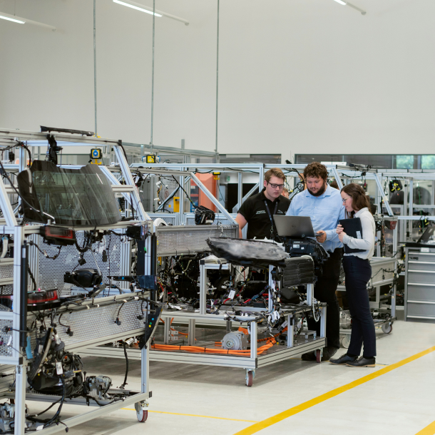 Manufacturing team reviewing product data on a factory floor to support EPD development, LCA reporting and decarbonization of construction materials with One Click LCA