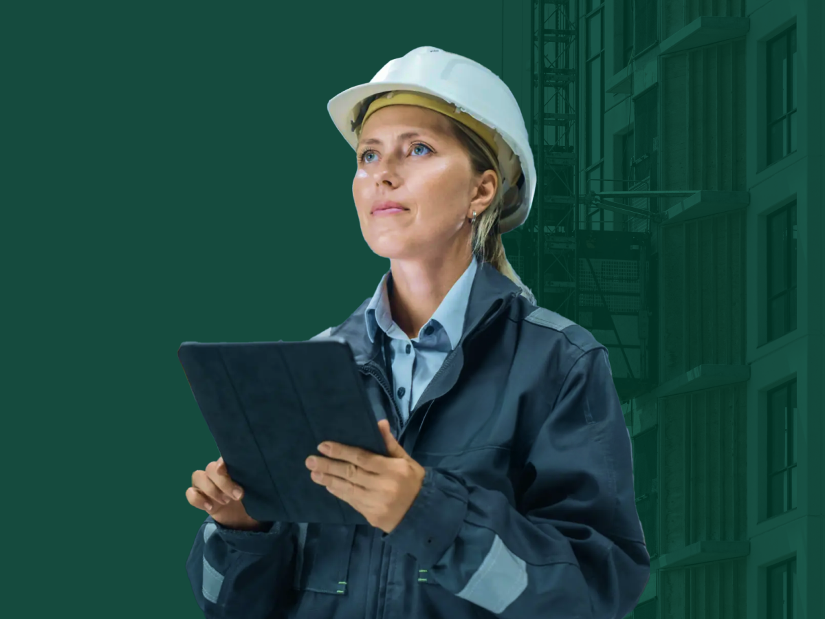 Construction professional using a tablet on a building site to assess EPD and LCA data for reducing embodied carbon in construction products and materials with One Click LCA